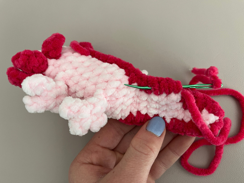Weave your yarn tail in the back loops of the tail to tidy the backside of the tail